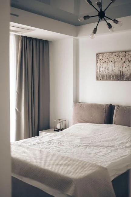 A cleaner works with a vacuum in a refined indoor space, demonstrating cleaning tools and methods.